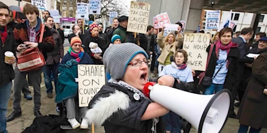 Tara Flood seeing in the forefront of a crowd of people protesting in Hammersmith & Fulham